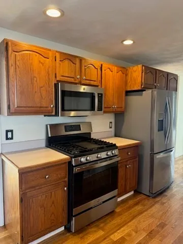 a kitchen with a stove a microwave a sink and a refrigerator