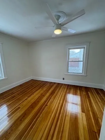 a view of wooden floor and brick walls