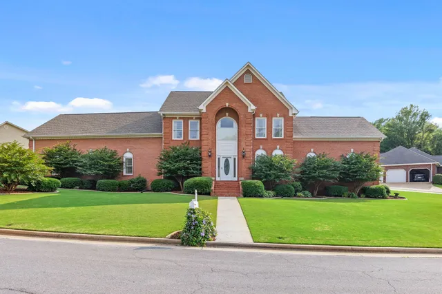 a front view of a house with a yard