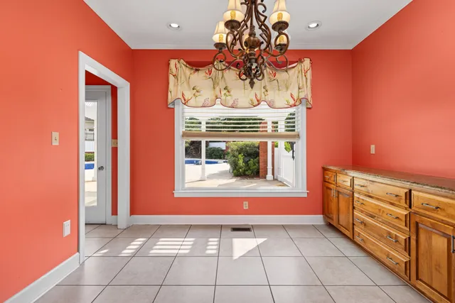 a dining room with furniture potted plants and wooden floor