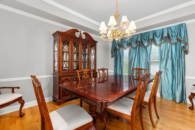 a view of empty room with wooden floor and fireplace