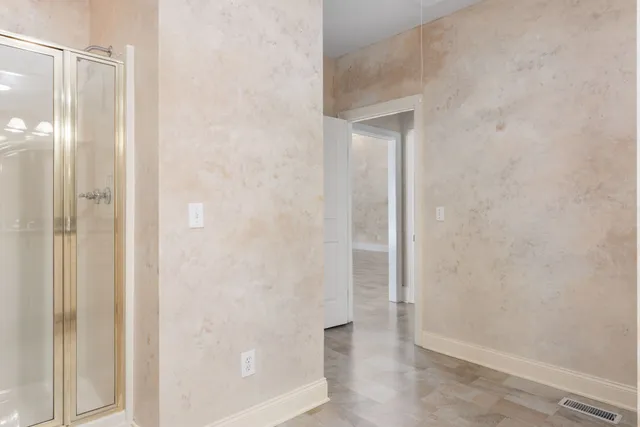 a view of an empty room with wooden floor