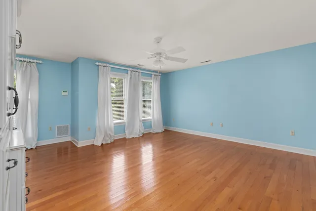 a bathroom with a granite countertop double vanity sink and mirror