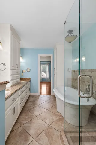 a bathroom with a granite countertop sink double and mirror