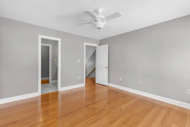 a bathroom with a granite countertop toilet a sink and mirror