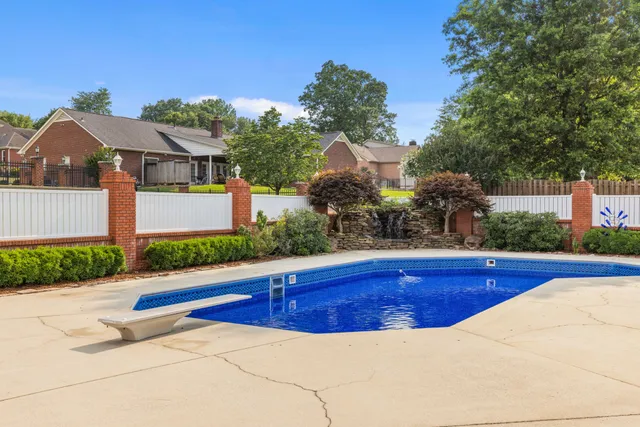 an aerial view of residential houses with outdoor space and pool