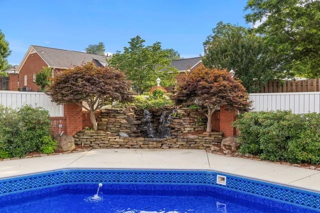 an aerial view of residential houses with outdoor space and pool