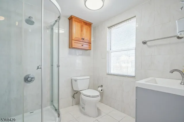a bathroom with a toilet sink and shower