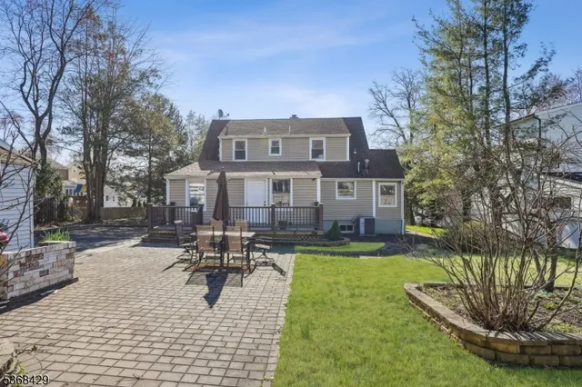 a view of a house with swimming pool and sitting area