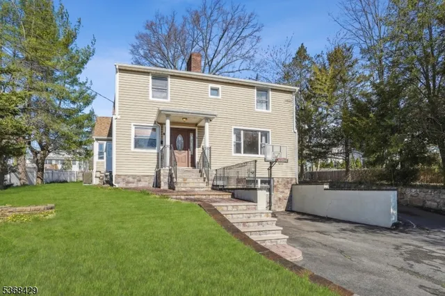 a view of a house with backyard and a tree
