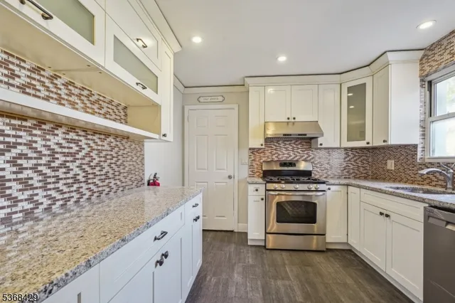a kitchen with a sink stove and cabinets