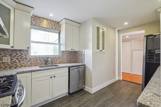 a kitchen with a refrigerator and a sink