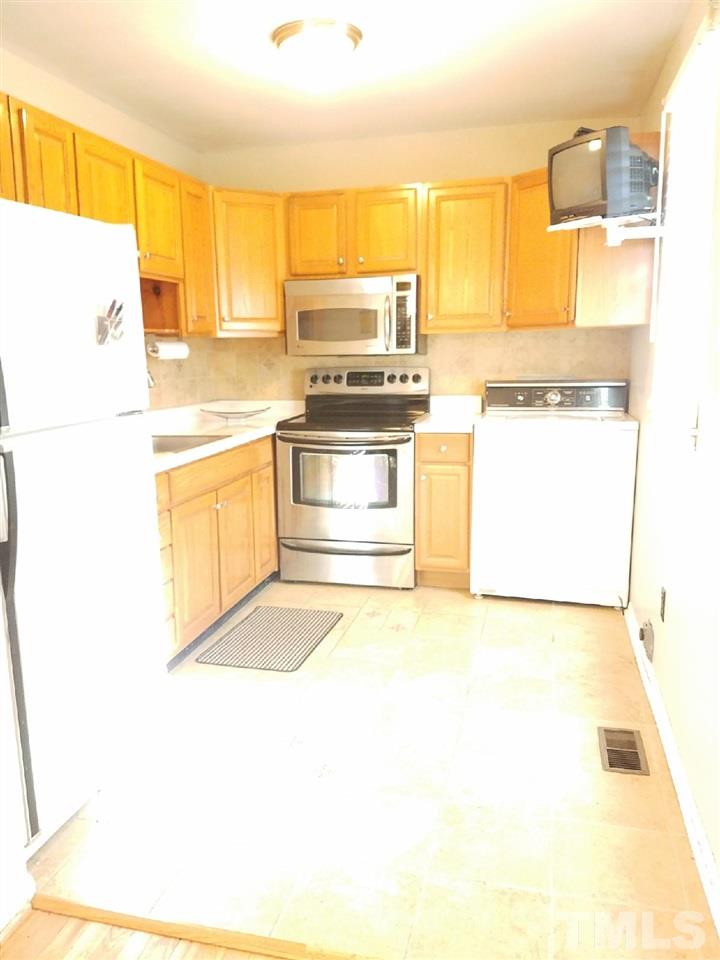 800 Newcombe Road Raleigh, NC 27610 - Photo 12 of 14 a kitchen with stainless steel appliances a stove a sink and a refrigerator
