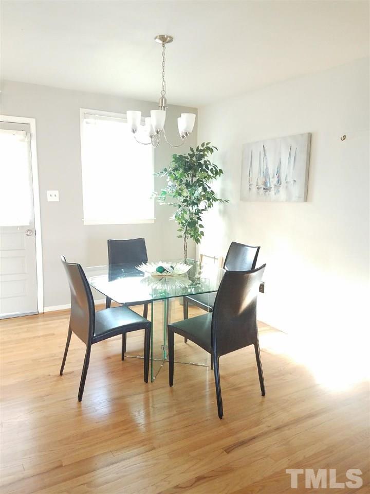 800 Newcombe Road Raleigh, NC 27610 - Photo 10 of 14 a view of a dining room with furniture and wooden floor