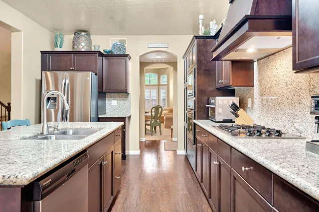 a kitchen with counter top space and dining table
