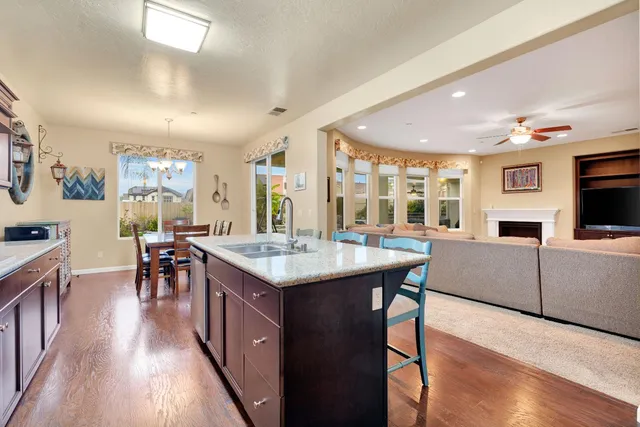 a kitchen with stainless steel appliances granite countertop a sink stove and cabinets