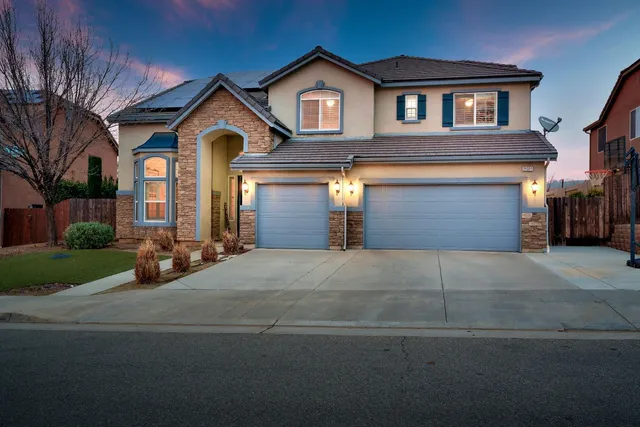 a front view of a house with yard