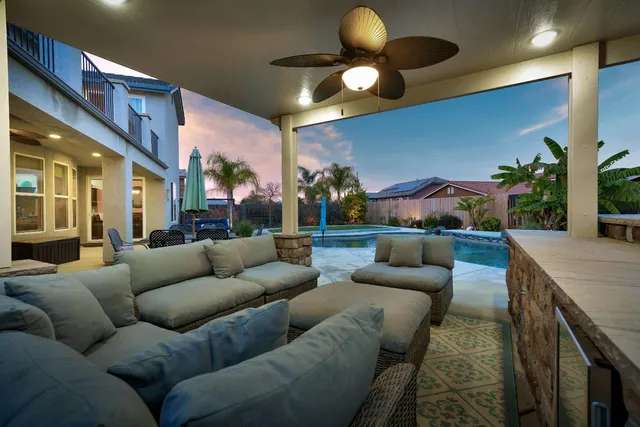 a front view of a house with swimming pool having outdoor seating