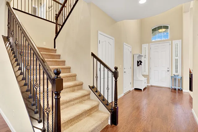 a view of an entryway with wooden floor and stairs