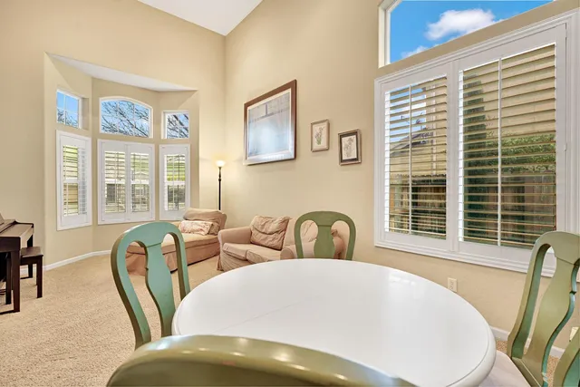 a view of a dining room with furniture and windows