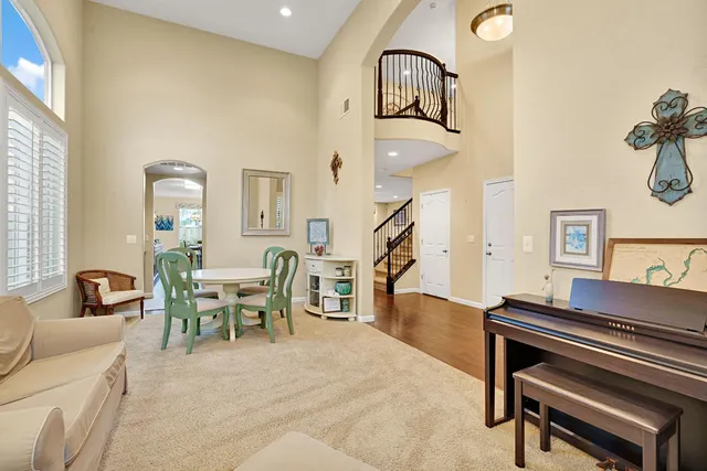 a living room with furniture and a piano