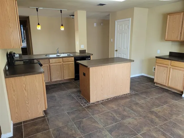 a kitchen with a stove cabinets and a refrigerator