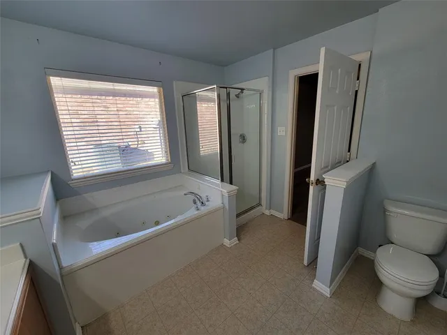 a white bath tub sitting next to a toilet