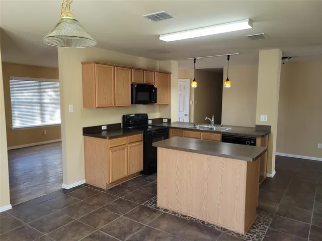 a kitchen with a sink cabinets and window
