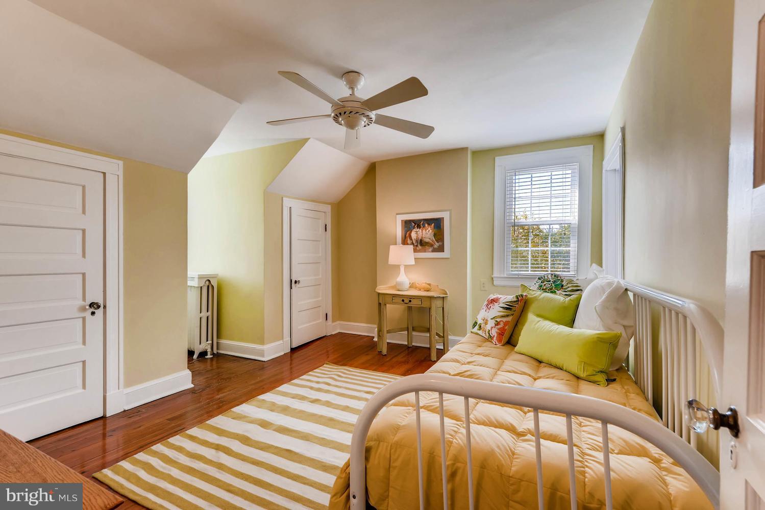 4330 Roland Avenue Baltimore, MD 21210 - Photo 22 of 29 a bedroom with a bed and wooden floor