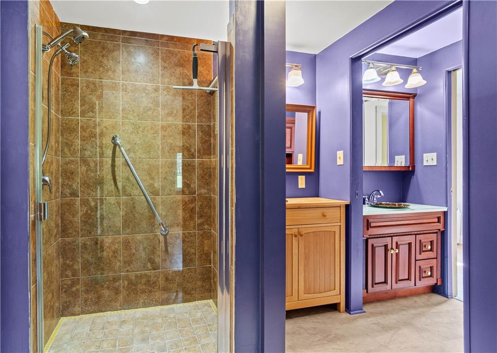 596 Wulfert Road Rochester Mills, PA 15771 - Photo 34 of 49 a bathroom with a granite countertop sink a mirror and a shower