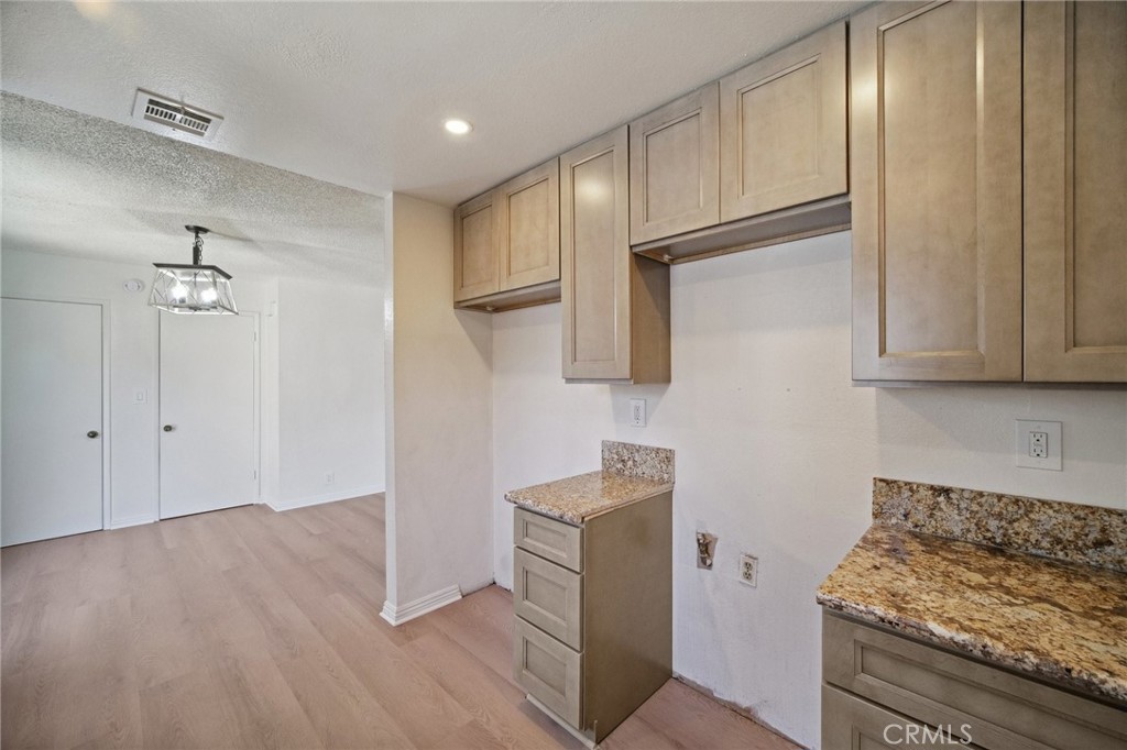 1926 Lucas Street, Unit 2 San Fernando, CA 91340 - Photo 12 of 35 a kitchen with stainless steel appliances granite countertop a refrigerator and a stove top oven