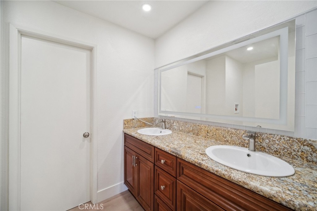 1926 Lucas Street, Unit 2 San Fernando, CA 91340 - Photo 19 of 35 a bathroom with a granite countertop sink and a mirror