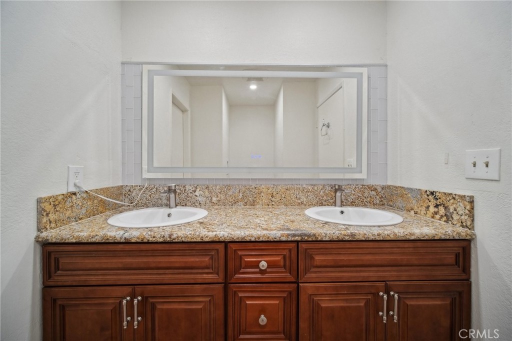 1926 Lucas Street, Unit 2 San Fernando, CA 91340 - Photo 21 of 35 a bathroom with a granite countertop sink and a mirror