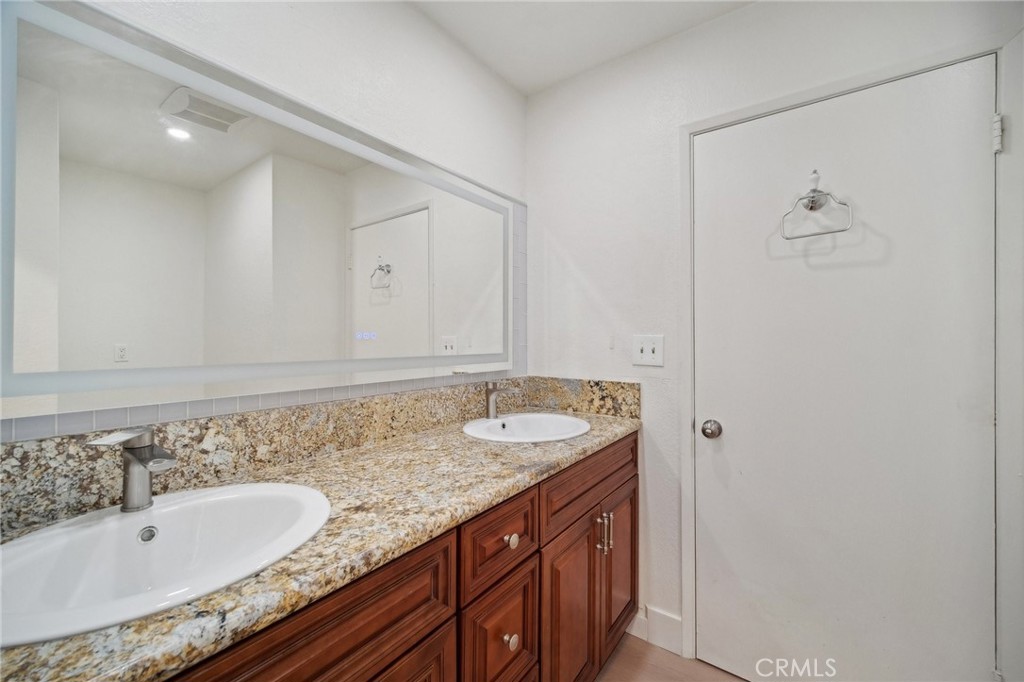 1926 Lucas Street, Unit 2 San Fernando, CA 91340 - Photo 23 of 35 a bathroom with a granite countertop sink and a mirror