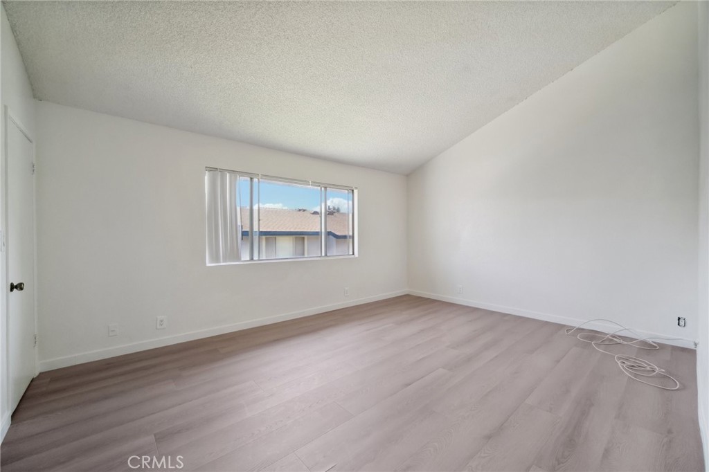 1926 Lucas Street, Unit 2 San Fernando, CA 91340 - Photo 26 of 35 an empty room with wooden floor and windows