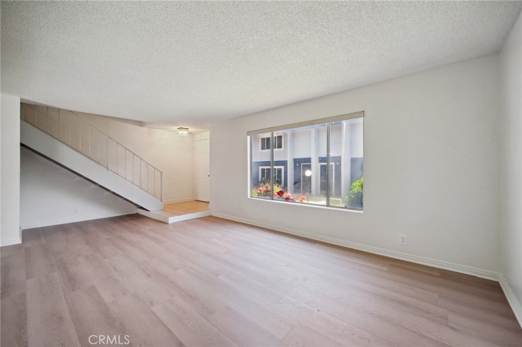 1926 Lucas Street, Unit 2 San Fernando, CA 91340 - Photo 4 of 35 an empty room with wooden floor and windows