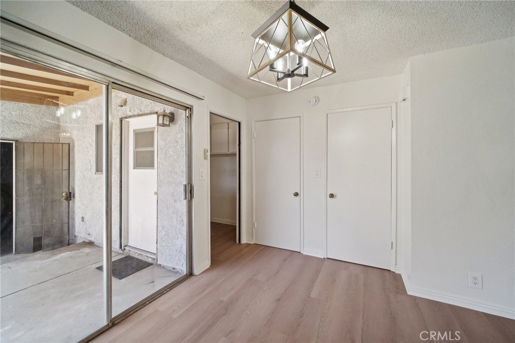 1926 Lucas Street, Unit 2 San Fernando, CA 91340 - Photo 9 of 35 a view of a hallway with wooden floor and chandelier
