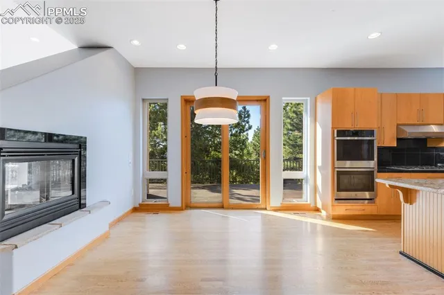 a view of a kitchen with a sink stove and a fireplace