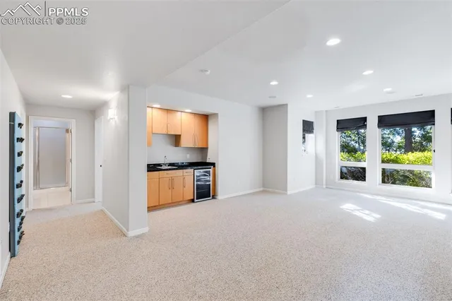a view of a kitchen with a sink and a large window