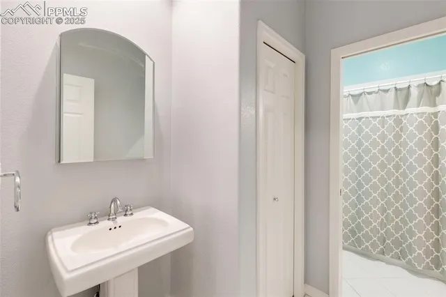 a bathroom with a sink a mirror and shower