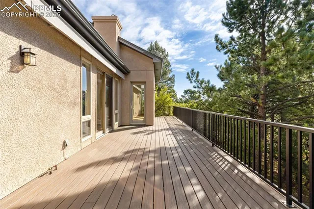 a view of a balcony with wooden floor and fence