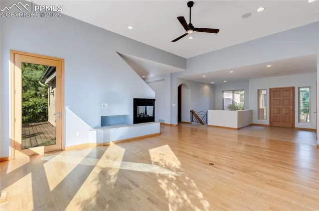 a view of a livingroom with furniture wooden floor and a kitchen