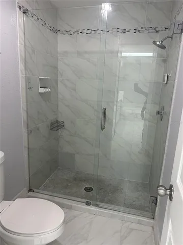 a bathroom with a shower and a toilet