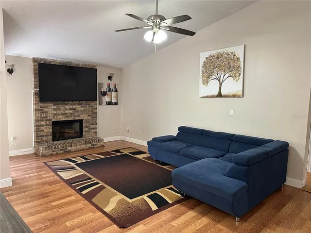a living room with furniture and a fireplace