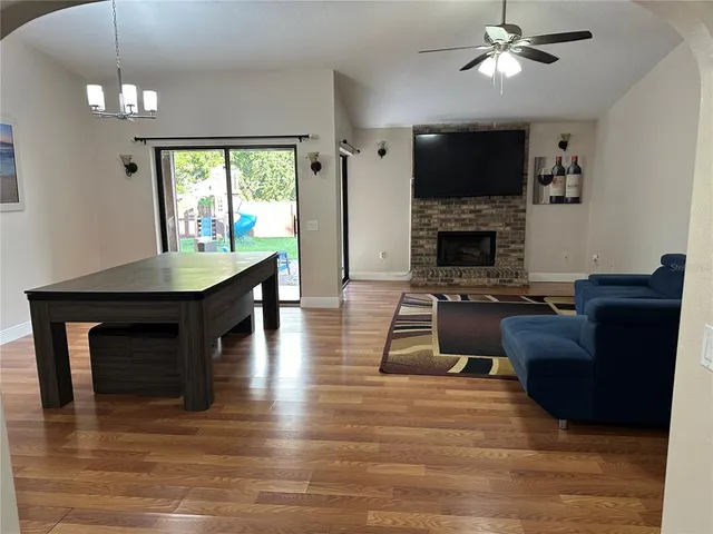 a living room with furniture a fireplace and a flat screen tv