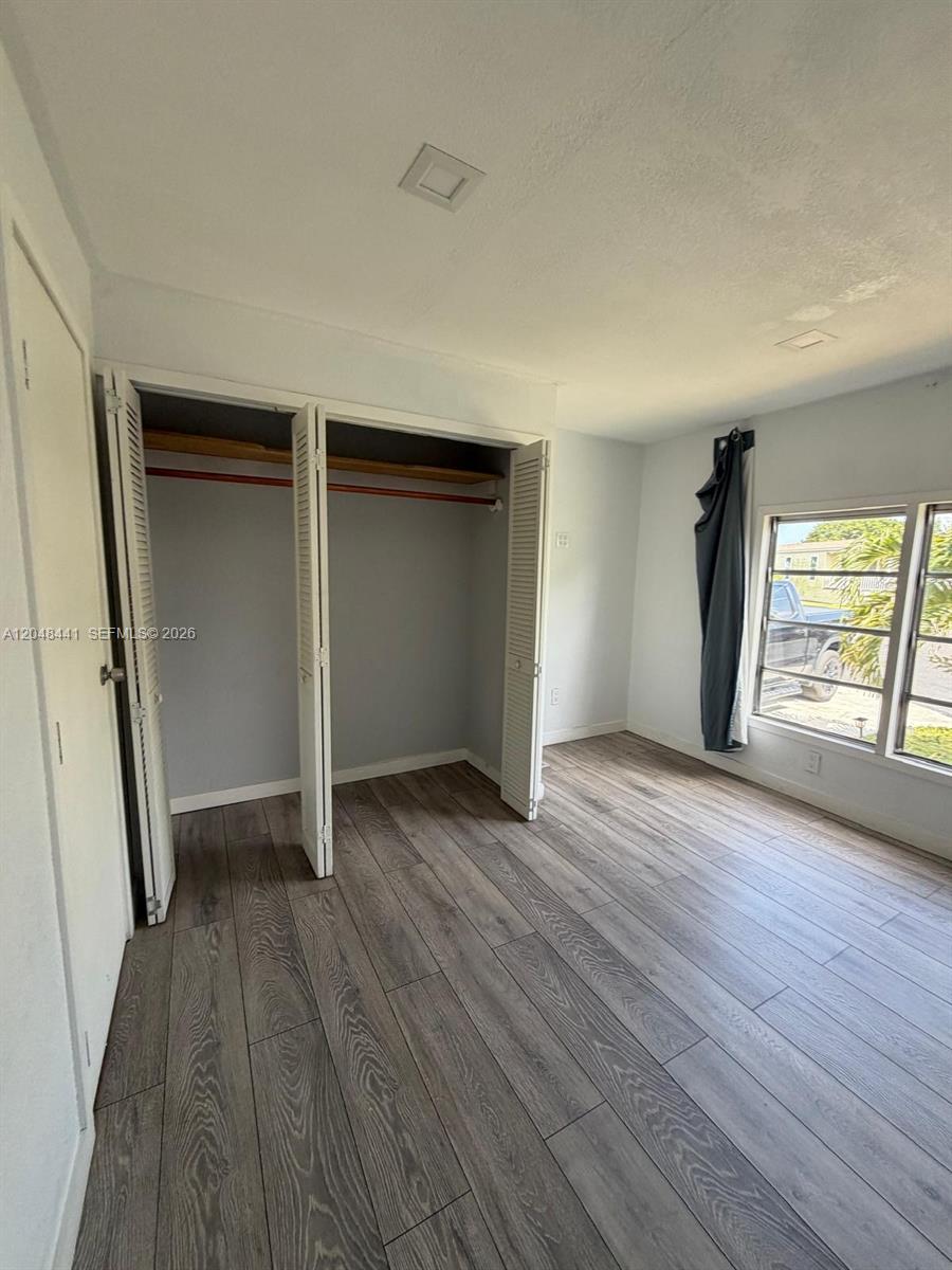 5331 Southwest 35th Street Davie, FL 33314 - Photo 12 of 31 an empty room with wooden floor and windows
