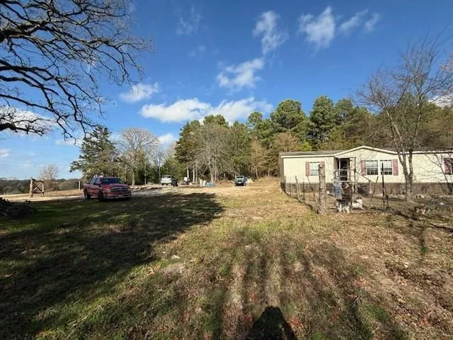 a view of a yard with a house in the background