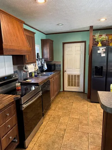 a kitchen with a stove a sink and a refrigerator