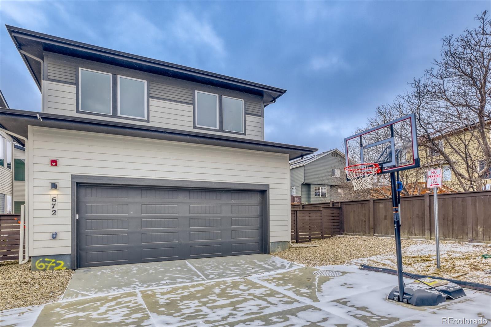 672 Apex Street Erie, CO 80516 - Photo 11 of 19 a front view of a house with a yard