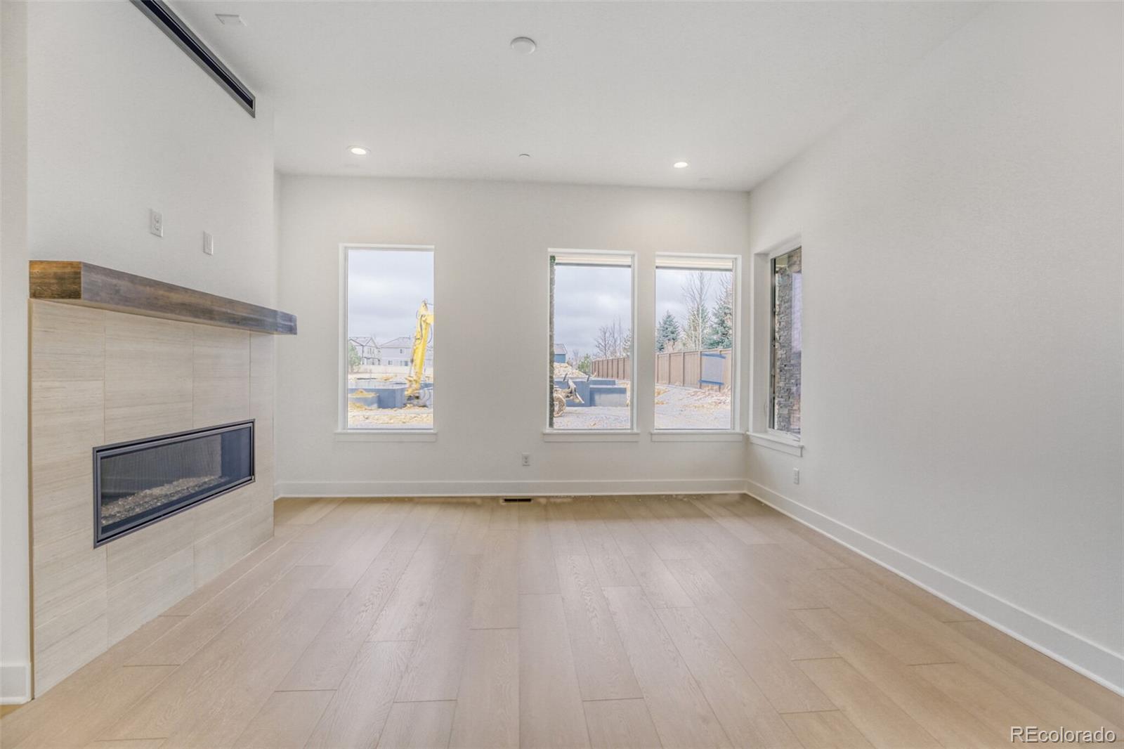 672 Apex Street Erie, CO 80516 - Photo 3 of 19 an empty room with windows and fireplace